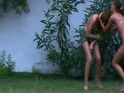 Three wet naked teenagers in a garden