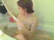 Brunette Masturbates With The Showerhead In The Bathtub