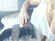 Sleek blonde and her guitar